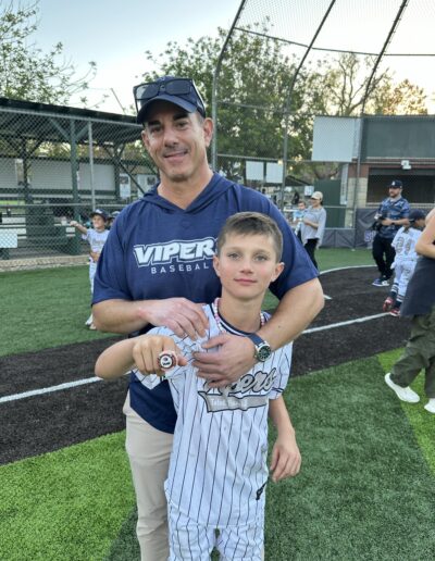Justin Milmeister and his son in a baseball game-min
